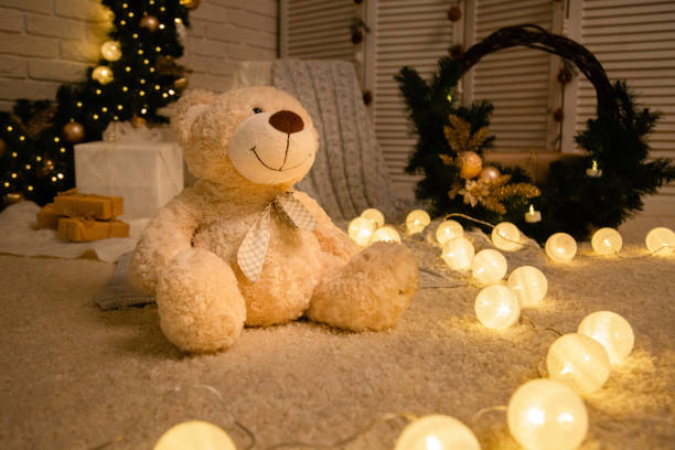 istock teddy bear on the background of Christmas decorations 1074976498