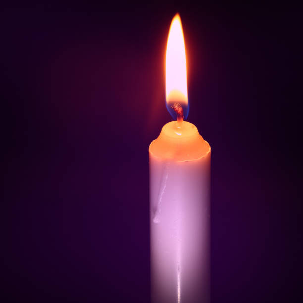 istock a burning candle in the dark 1074976512