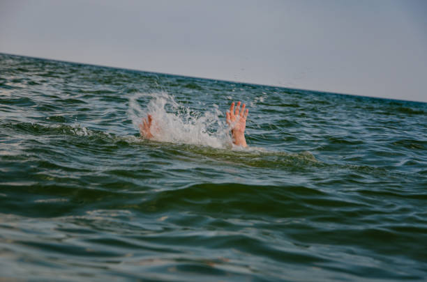 istock Hands of a man in the sea 1074980500