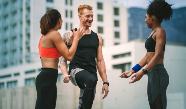 istock Fitness colleagues standing on rooftop and talking 1074981010