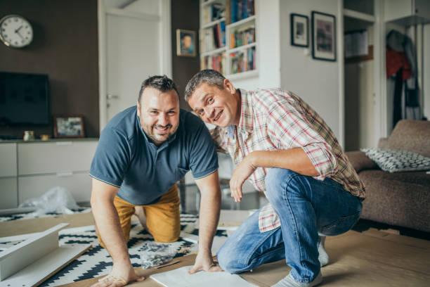 istock Two friends assembling furniture 1074982792