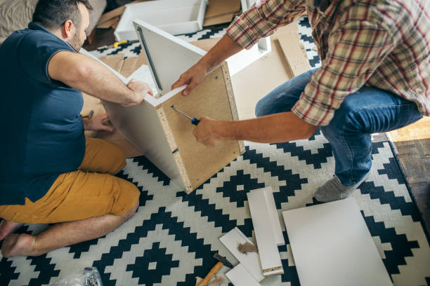 istock Two friends assembling furniture 1074982892