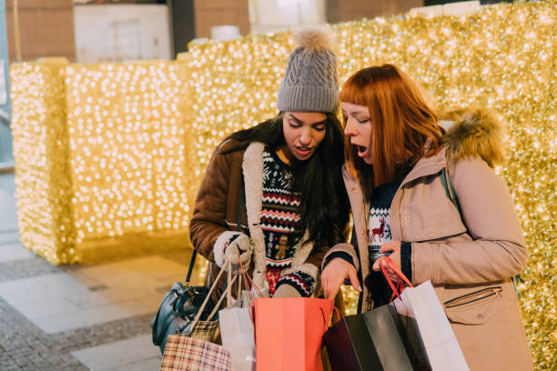 istock Friends looking at shopping bag 1074983732