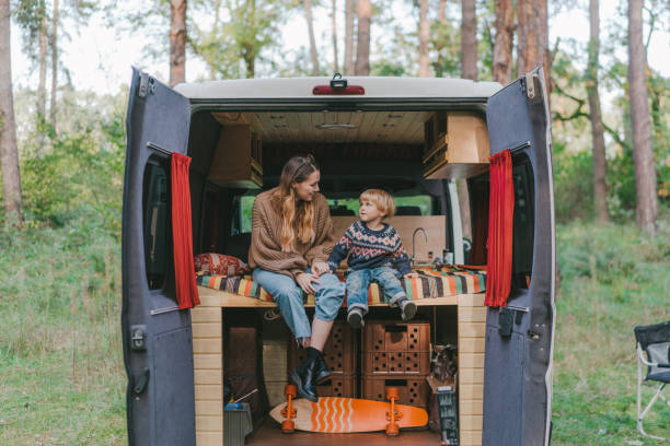 istock Woman with son sitting in camper van 1074985486
