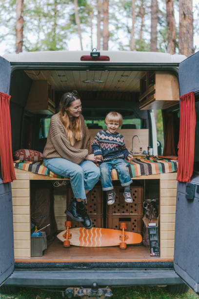 istock Woman with son sitting in camper van 1074985492