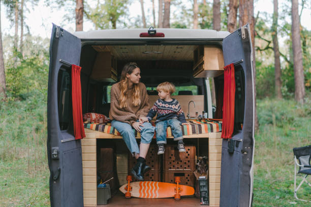 istock Woman with son sitting in camper van 1074985618