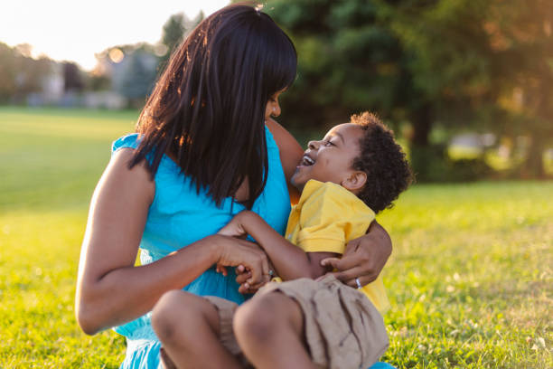istock Mother and son playing in a park 1074985686