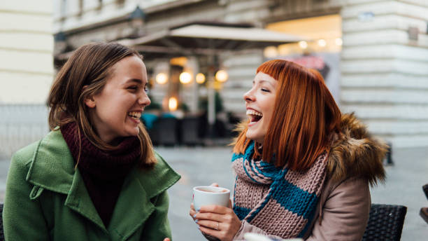 istock Girls drinking coffee and smiling 1074985944