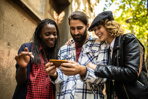 istock Three friends looking at the smart phone 1074986478