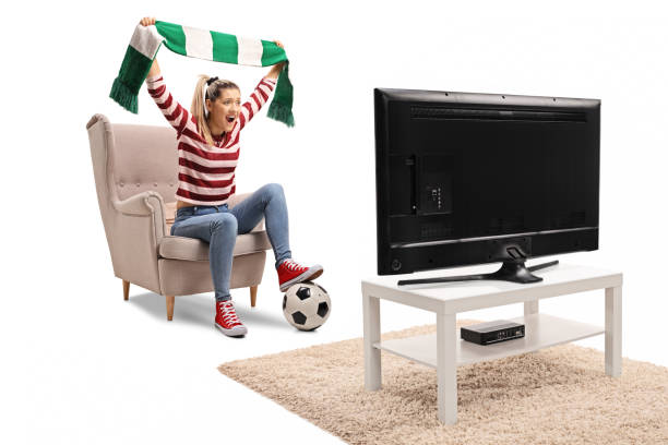 istock Female soccer fan cheering with a scarf and watching a game 1074993436