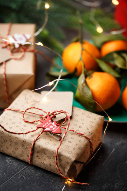 istock Top view of a table with tangerines, candles, and gift boxes 1074999672