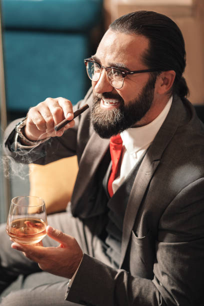 istock Exhausted nervous man smoking cigar and looking into window 1075003758