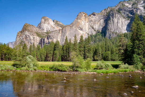 istock merced river in yosemite Park with rocks 1075006346
