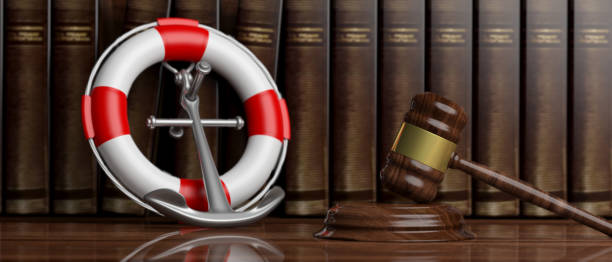 lifebuoy, ancora della nave della marina e martello del giudice su sfondo libri di legge, striscione. illustrazione 3d - court legal system justice gavel foto e immagini stock