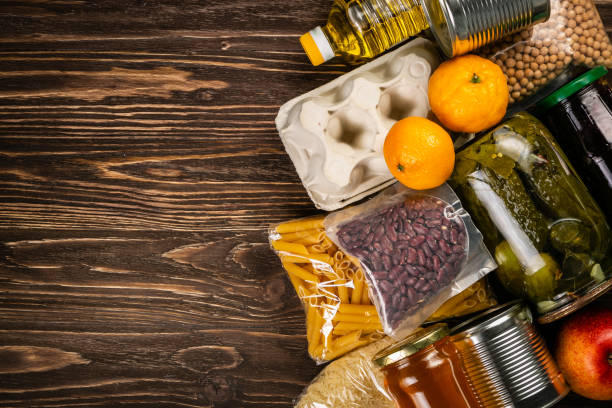 istock Food donations in box in kitchen background 1075011388