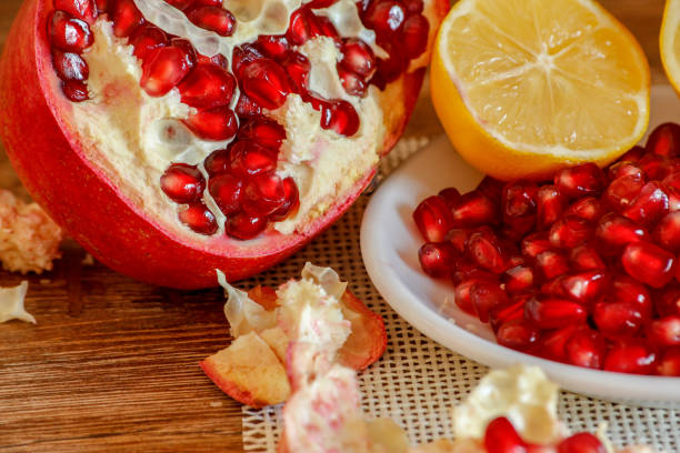istock Ripe pomegranate and lemon on a ceramic plate 1075012432