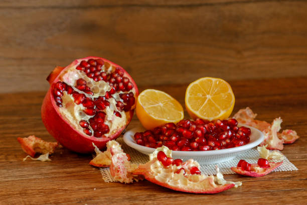 istock Ripe pomegranate and lemon on a ceramic plate 1075012720