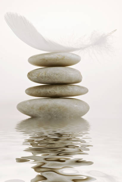 istock Zen garden with stone pyramid reflected in the clear water 1075019656