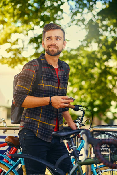 istock A man using a smart phone near bicycle parking. 1075023030