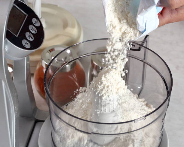 istock Pouring flour into mixer. Making Treacle Pie Series. 1075024404