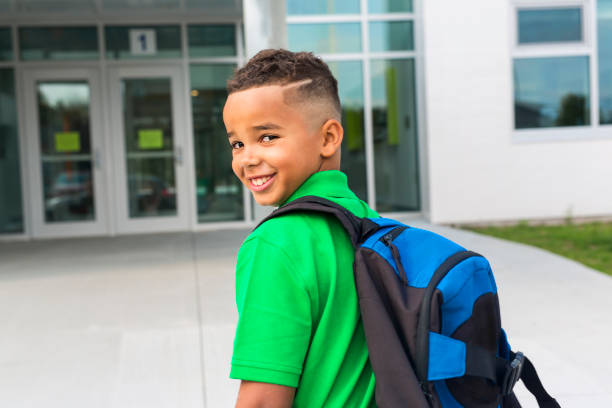 istock cheerful african american primary school boy with backpack 1075025044