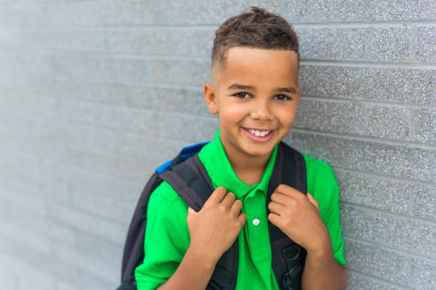 istock cheerful african american primary school boy with backpack 1075027064