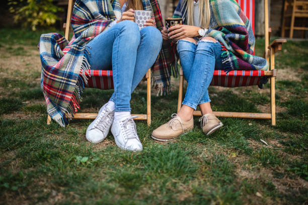 istock Modern girlfriends enjoying a hot drink on a autumn day 1075036346