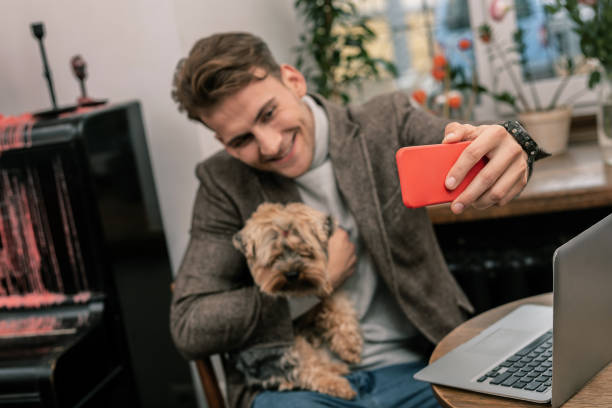 Man making a selfie with his little dog