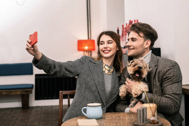 istock Woman making a selfie with her partner and a dog 1075041306