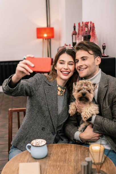 istock Young couple making selfie with their dog 1075041308