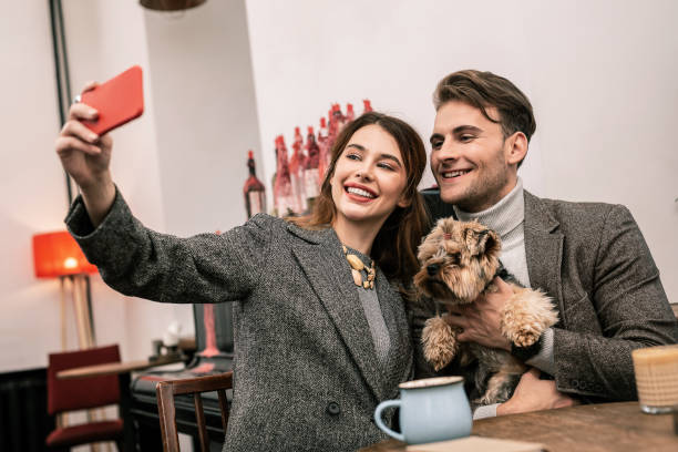 istock Smiling young family making selfie with their pet 1075041338