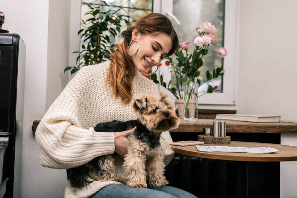 istock Young woman happily holding her small dog 1075041344