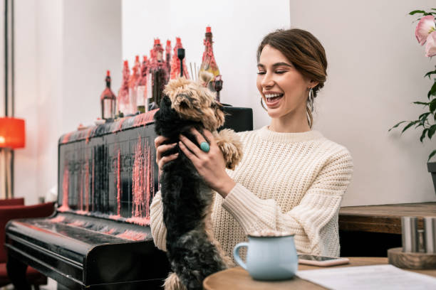 istock Woman is happy playing with her small dog 1075041392