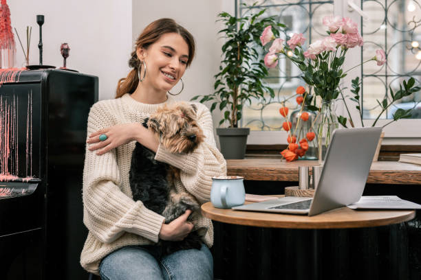 istock Woman working in a cafe with her dog 1075041396