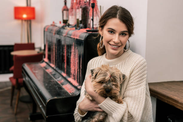 istock Smiling young woman hugging her terrier dog 1075041400