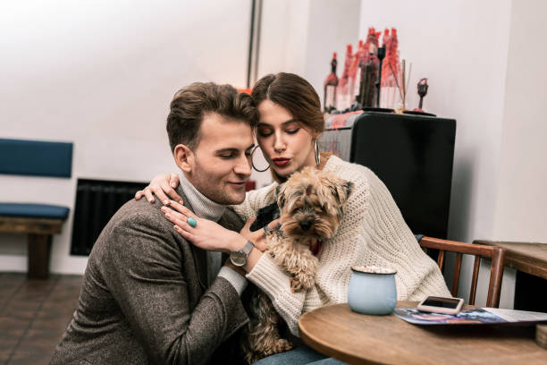 istock Happy couple is getting a small funny dog 1075041438