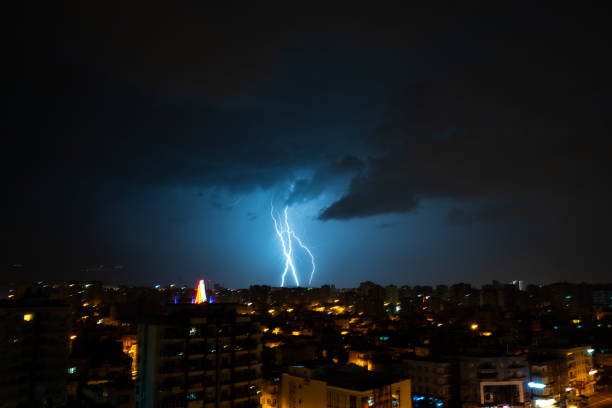 istock dark clouds and lightning above city at night 1075041462