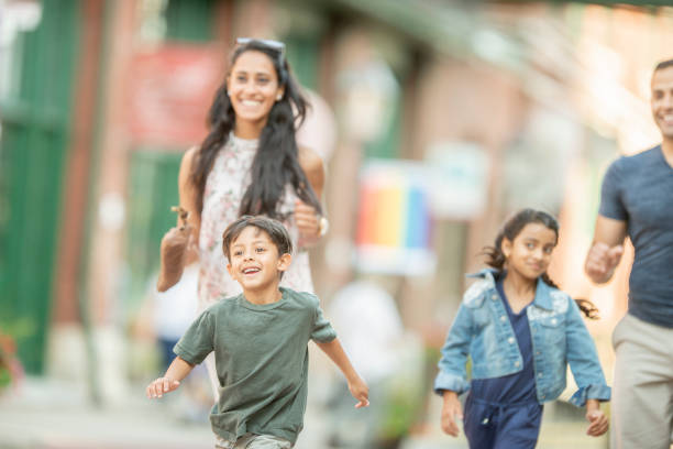 istock Family running through the city 1075043388