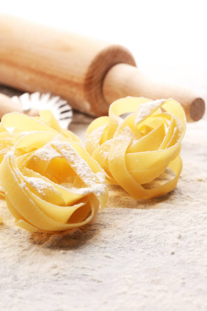 istock pasta. Fresh homemade pasta with pasta ingredients on the rustic table. 1075045236