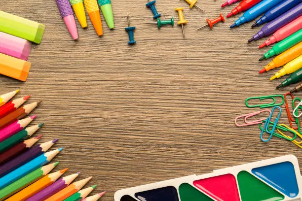 Bright school accessories, stationery on a wooden background. Top view