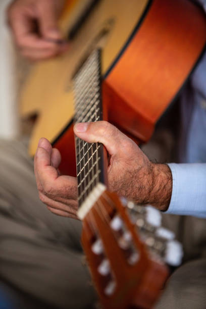 istock Senior man playing guitar 1075052720