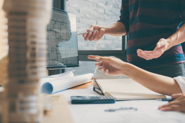 istock Team of Construction engineering or architect hands working on blueprint inspection in workplace, drawing and sketching meeting for architectural project working with partner 1075053516