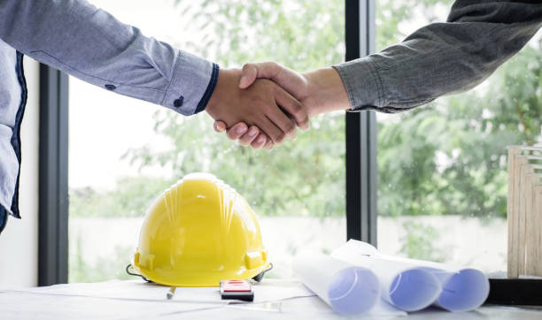 istock Shaking hands of collaboration, Construction engineering or architect discuss a blueprint while checking information on drawing and sketching, meeting for architectural project of partner 1075053590