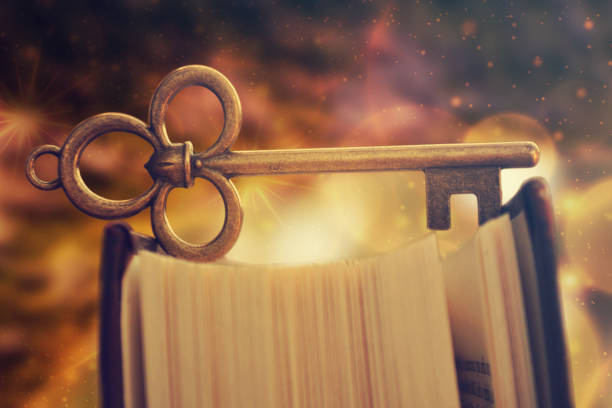 istock Old antique key standing on book. Education concept, reading is the key. 1075055318