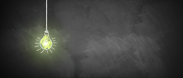 shining lightbulb drawn on an empty chalkboard