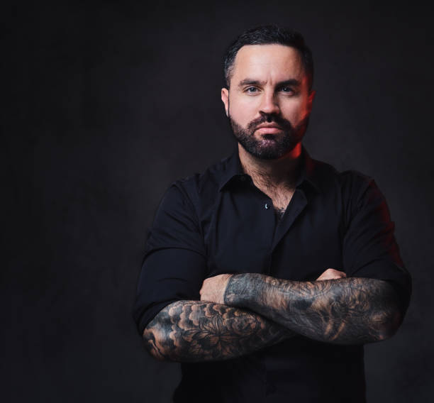 istock A man with tattoos on his crossed arms. 1075065414