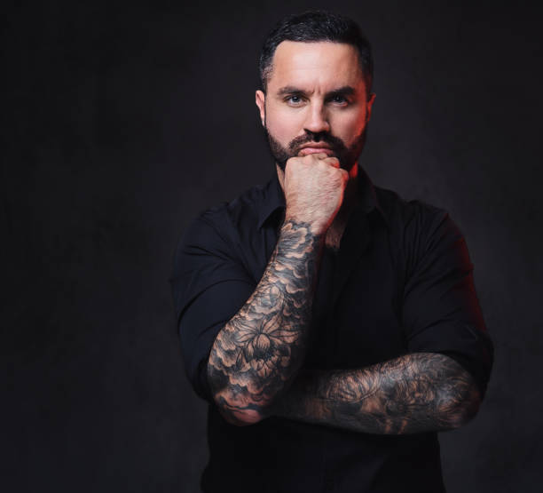 istock A man with tattoos on his crossed arms. 1075065658