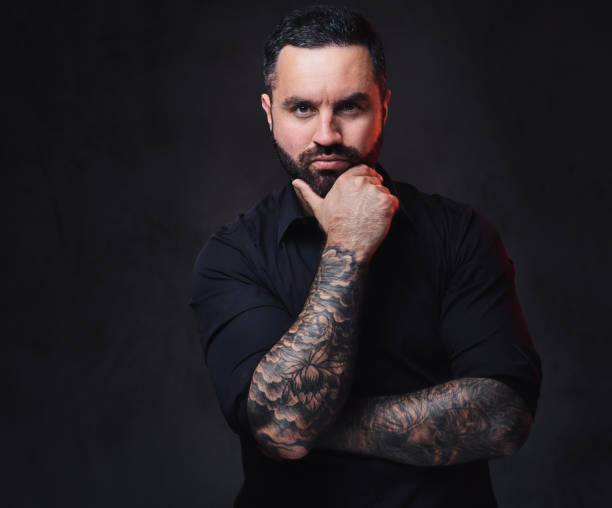 istock A man with tattoos on his crossed arms. 1075065992