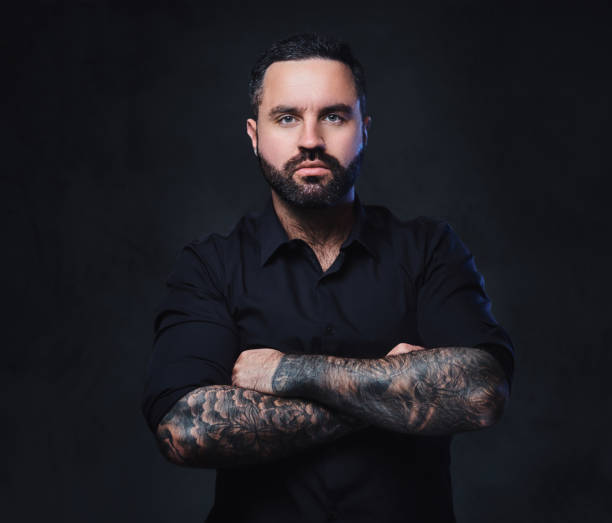 istock A man with tattoos on his crossed arms. 1075066156