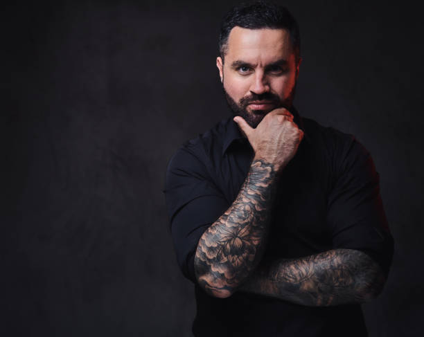istock A man with tattoos on his crossed arms. 1075066170